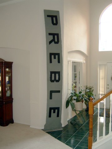 Tim, a regional facilities manager, keeps a piece of the USS Preble in the entryway of his home. 