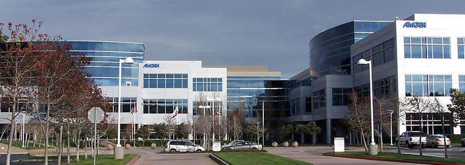 A large office building with cars parked in front of it.