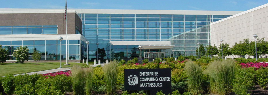 A large building with a sign in front of it.