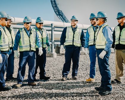 A group of maintenance workers standing in front of an Aboveground Storage Tank