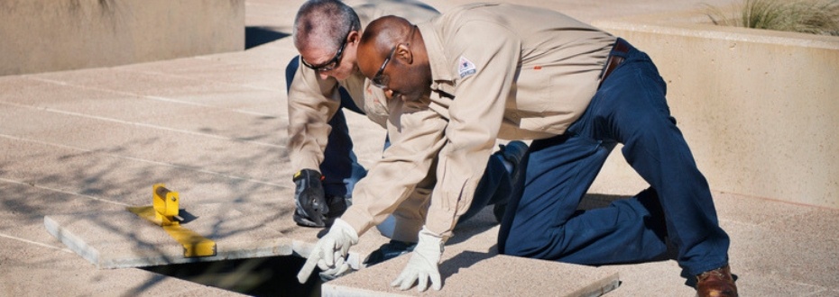 Two C&W Services employees inspect the floor at Toyota.