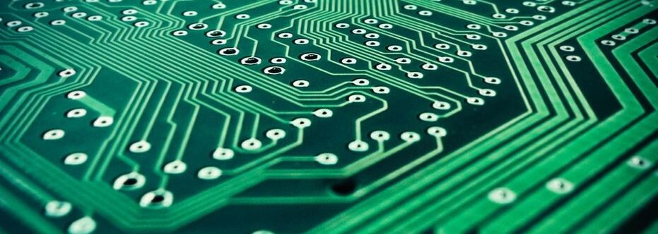 Close up of a green circuit board.