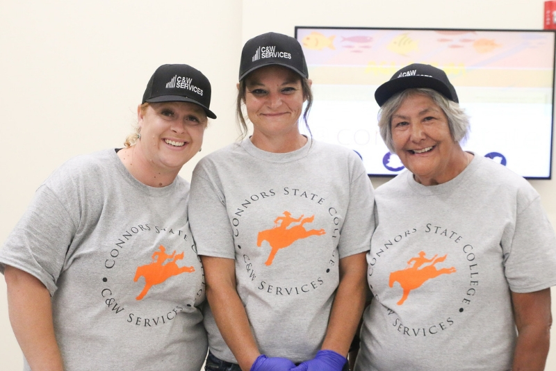 Three C&W Services employees organize a community dinner for flood and severe weather victims. 