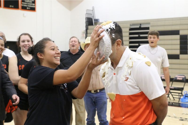 The coach of the Connors State College Women's Basketball team gets a pie in the face