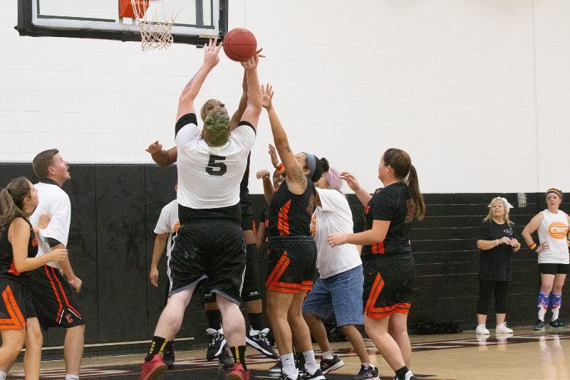 A C&W Services janitor scores a basket with a layup.