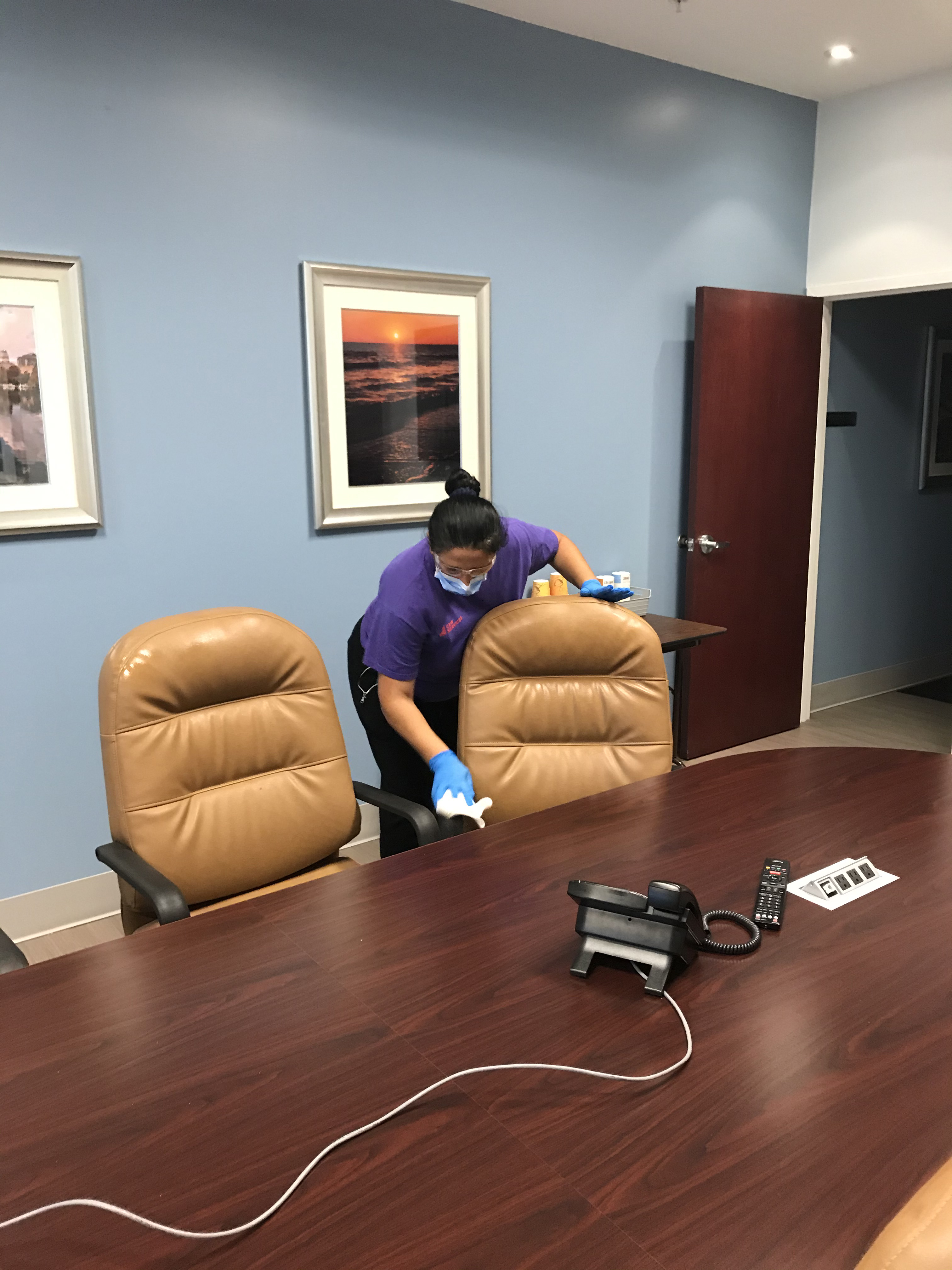 A C&W Services team member cleans a hallway to make sure it's safe and clean.