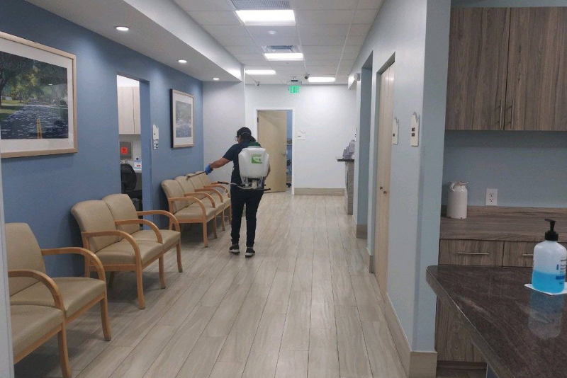 A C&W Services team member cleans a hallway to make sure it's safe and clean.