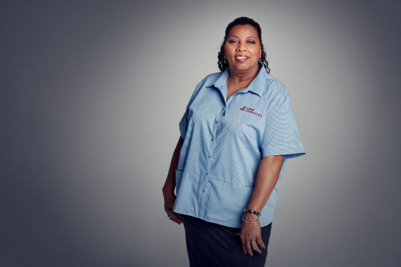 A woman in a blue shirt posing for a photo.