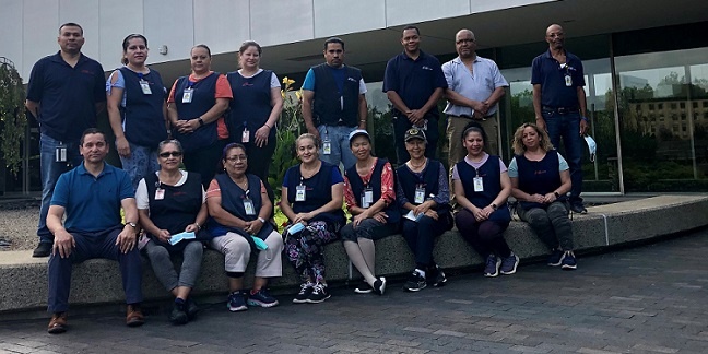 A group of people posing for a photo in front of a building.