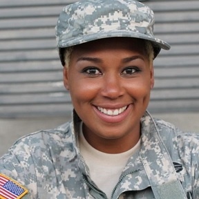 A woman in military uniform smiling for the camera.