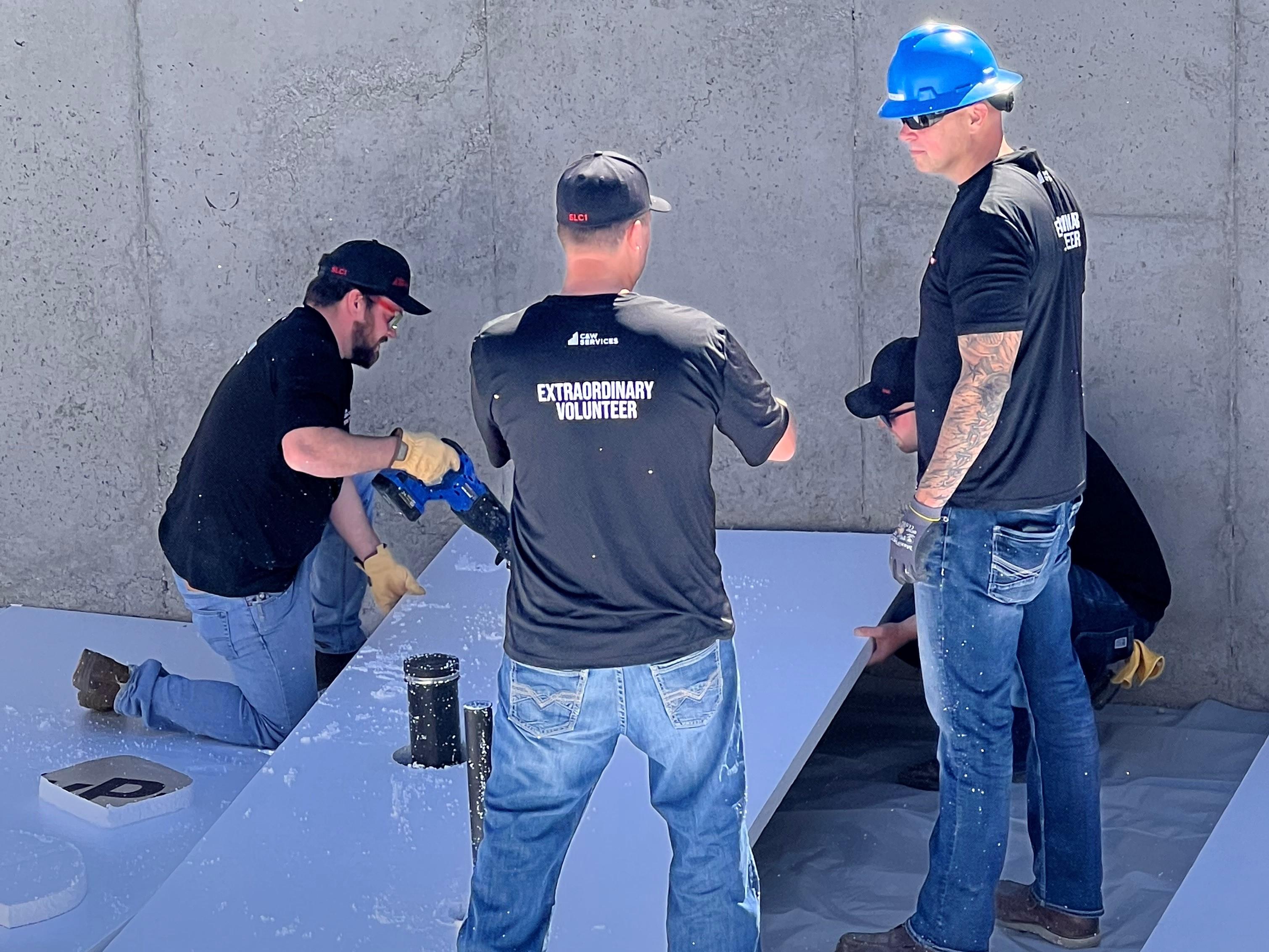 C&W Services volunteers installing basement flooring at Habitat for Humanity site