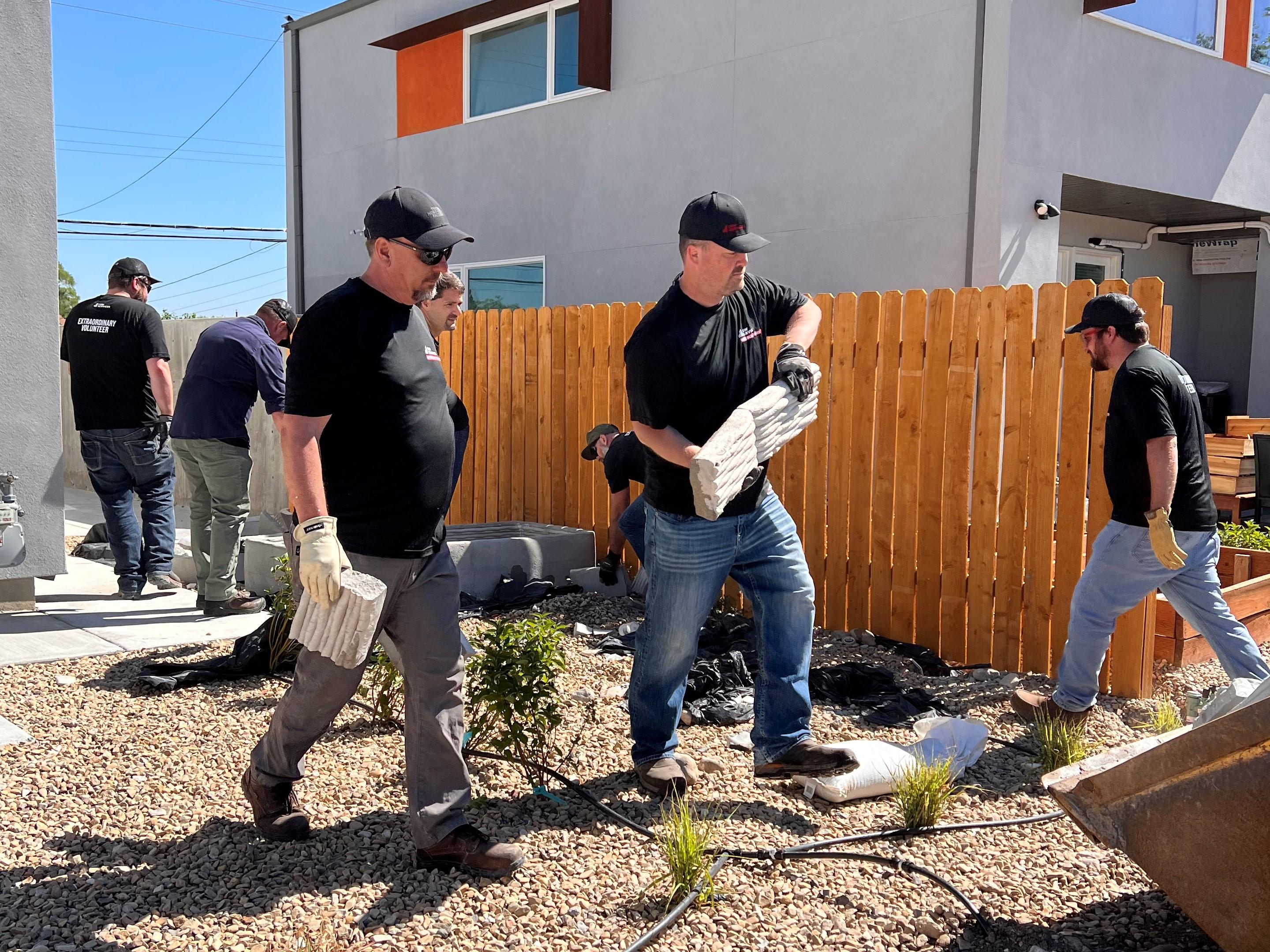 C&W Services volunteers installing landscaping materials at Habitat for Humanity site