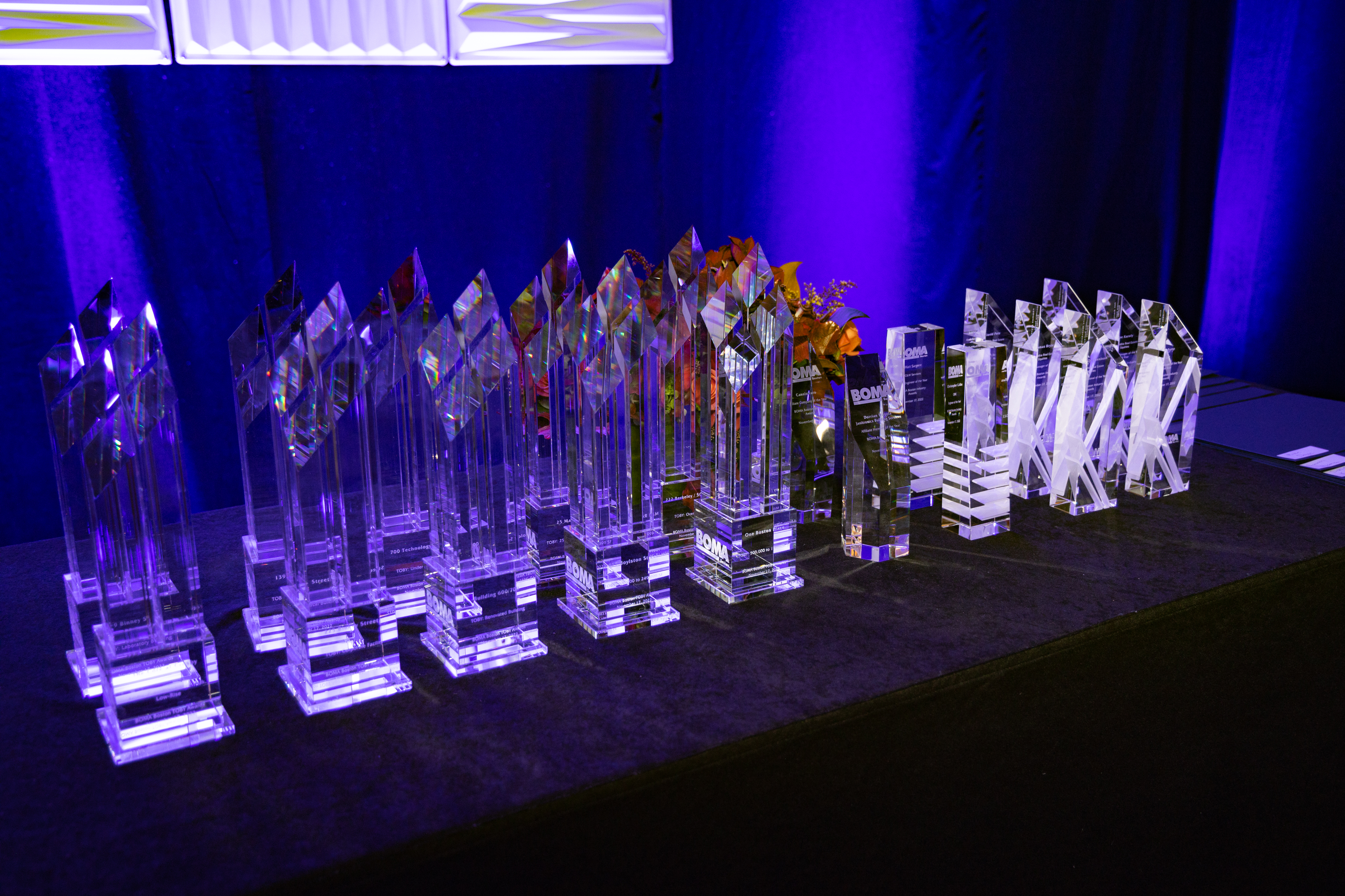 A table with a lot of awards on it.