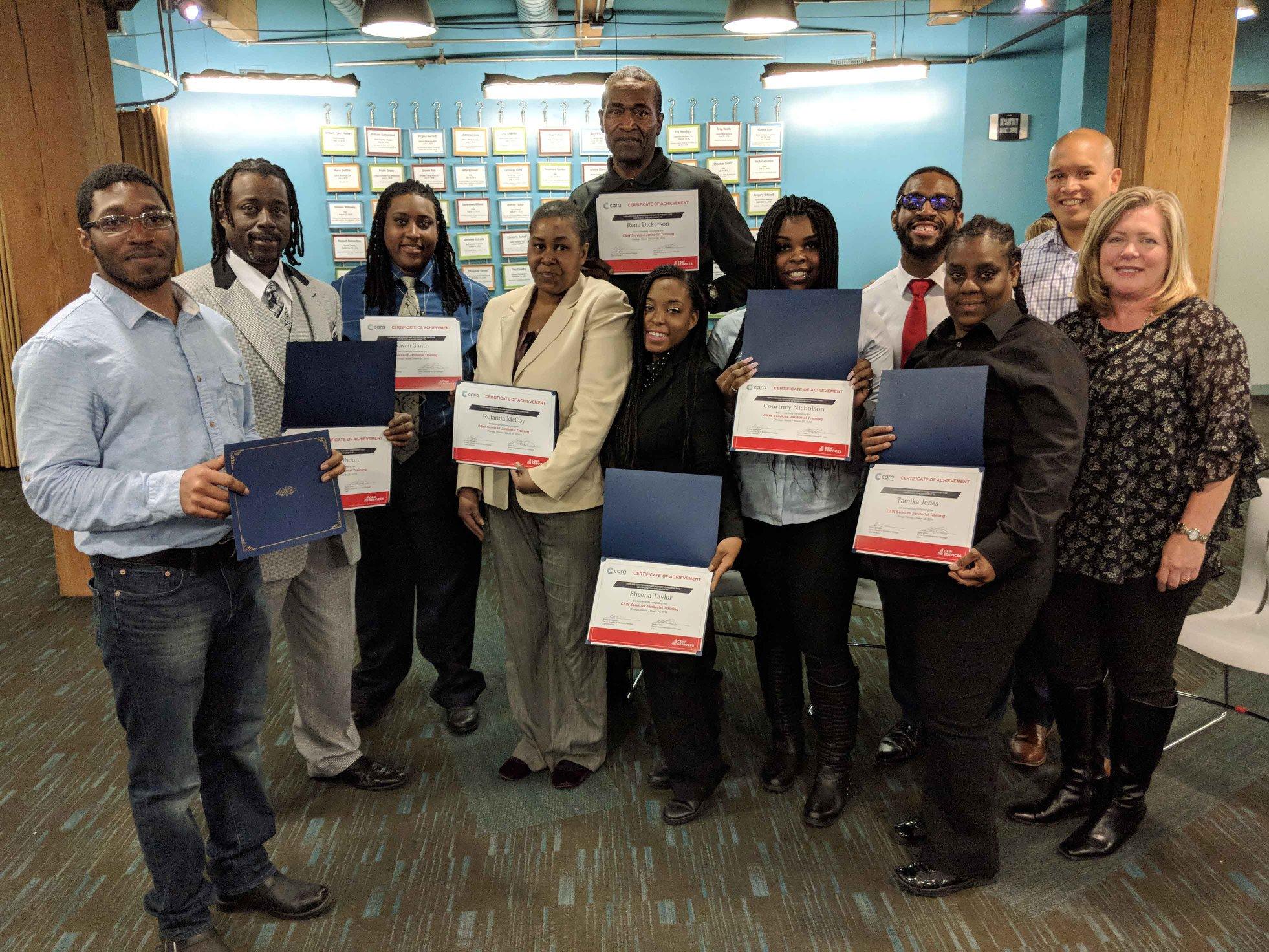 A group of people posing with their certificates.