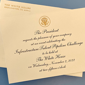 A white house invitation with the president's seal on it.