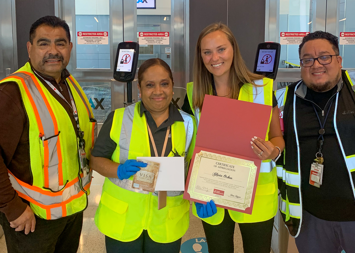 A group of people wearing safety vests and holding a certificate