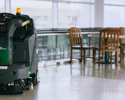 A robot cleaning the floor of an airport.