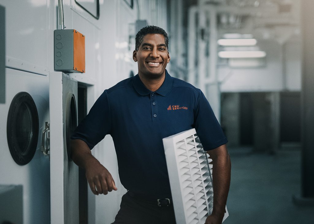 A man holding a vent for facility services.