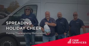 Four men in blue shirts stand in front of a van holding turkeys. Text reads: "Spreading Holiday Cheer: Making Thanksgiving Memorable." C&W Services logo is visible.