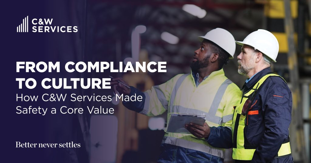 Two workers in safety gear stand in an industrial setting, examining something off-frame, with text about C&W Services making safety a core value.
