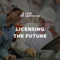 Two people wearing hard hats review plans or documents in an industrial setting. Text overlay reads "C&W Services Licensing the Future.