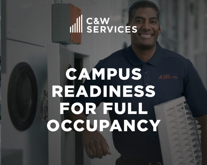 A man in a C&W Services uniform stands indoors holding an air vent, with the text “Campus Readiness for Full Occupancy” overlaid.