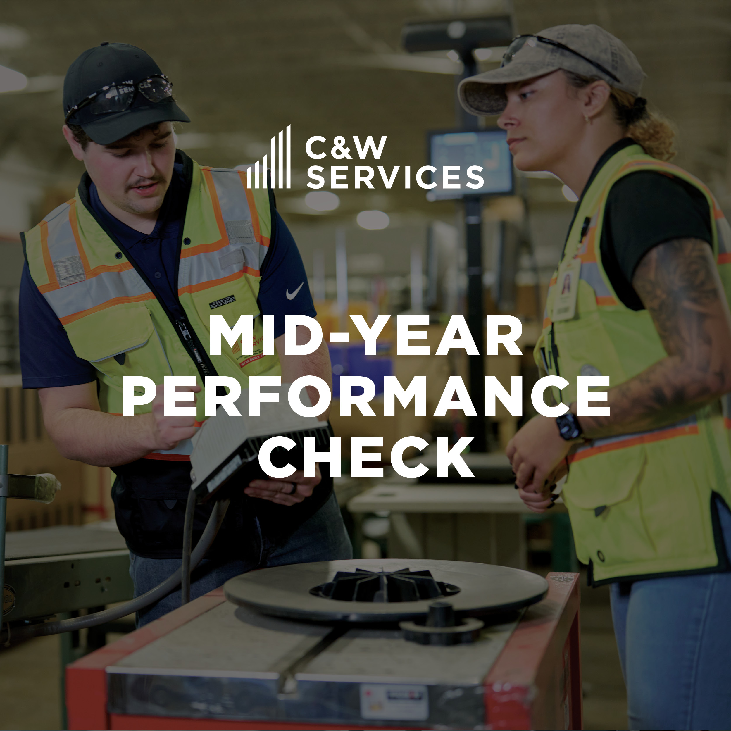 Two workers in safety vests discuss near industrial equipment, with "C&W Services Mid-Year Performance Check" text overlayed.